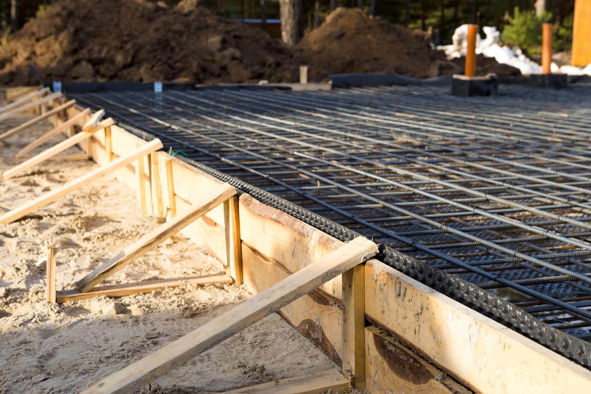 Iron fittings on a wooden formwork with laid pipes are the basis